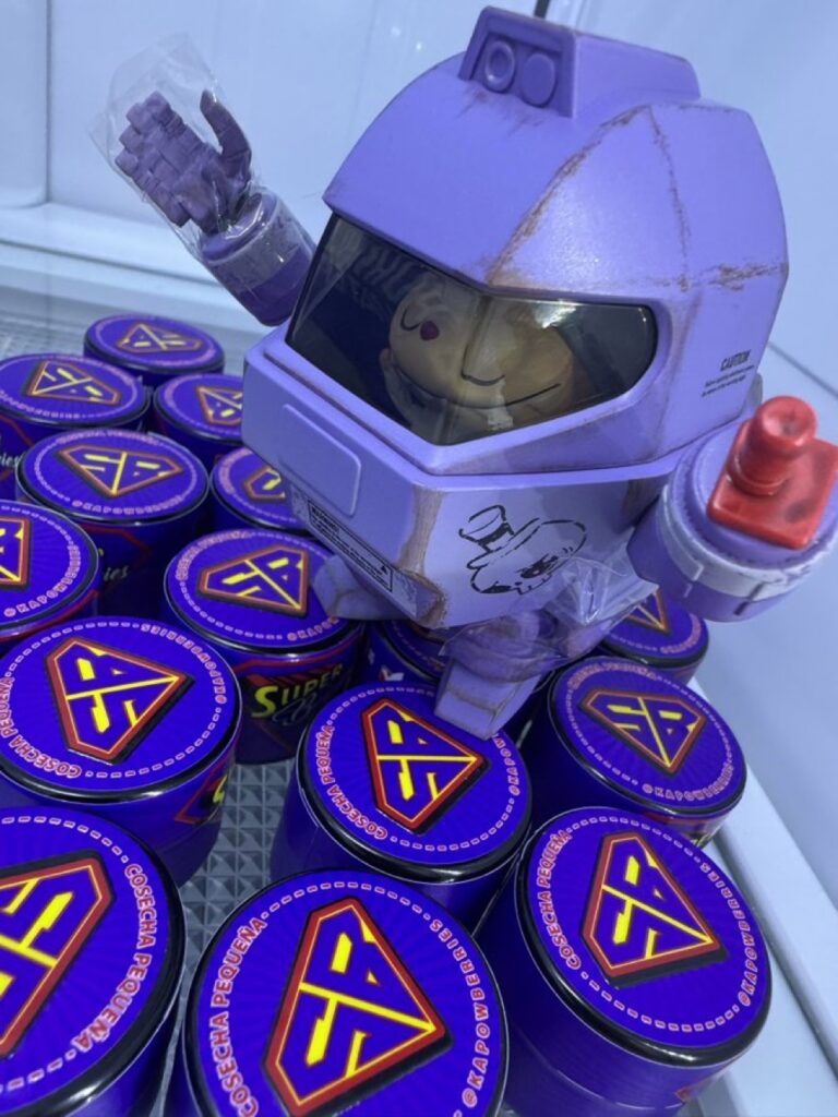 Jar of KapowBerries Super Berries hash rosin — cold cure solventless concentrate with rich amber texture, set on a branded display at Hash Holes & Donuts LA 2025.