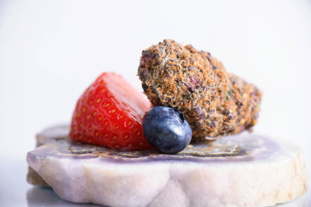 A bowl of fresh fruit containing chunks of cantaloupe and honeydew melon mixed with whole blueberries, raspberries, and blackberries.