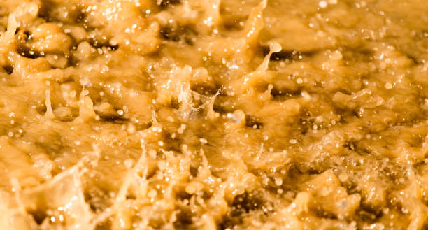 A close-up view of Kapow Berries Super Berries cold-cured hash rosin, showing its glistening texture and purple hue.