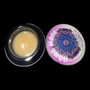 Open jar of Kapow × Handmade Berries & Cream solventless hash rosin with creamy light-yellow concentrate next to the colorful Hand Made Hash lid featuring a psychedelic mandala design
